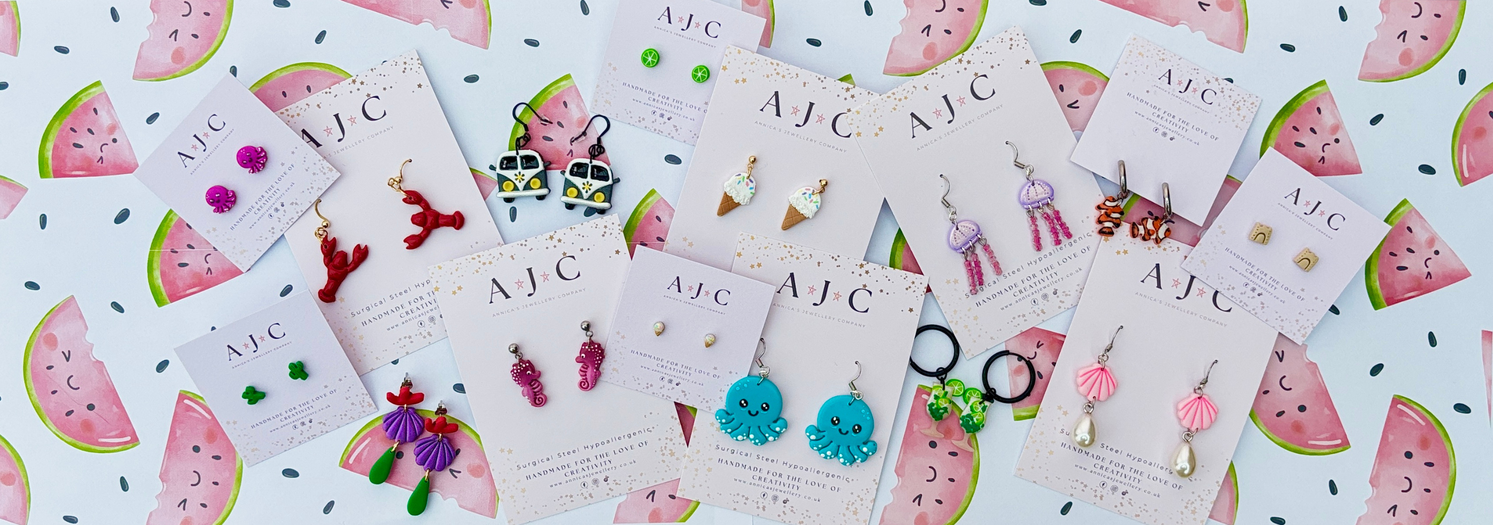 A range of colourful summer inspired earrings from animals, and beach inspired items to ice creams and camper vans, spread out on pastel watermelon background theme